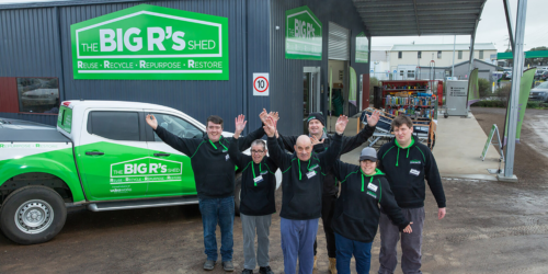 Are-able Social Enterprise Business The Big R's Shed is fast becoming a thriving community hub. Staff standing in from of the shed welcoming customers in.