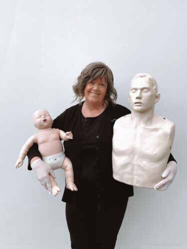 First Aid trainer kris with infant and adult first aid dummy