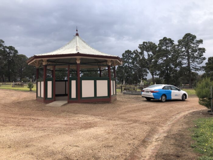 The restored rotunda with an are-able car parked beside it.