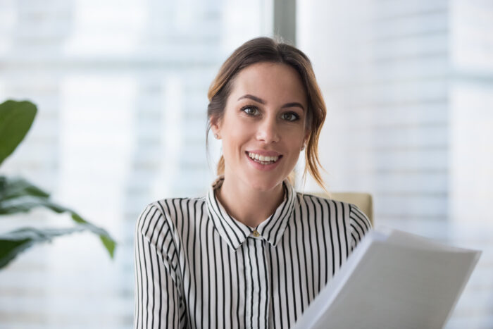 Interviewer sitting at desk looking at camera