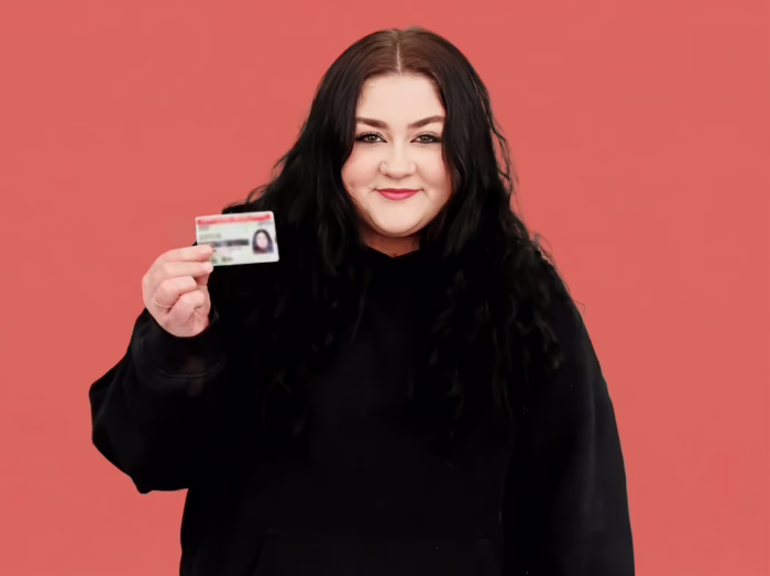 Porsha holding her licence.